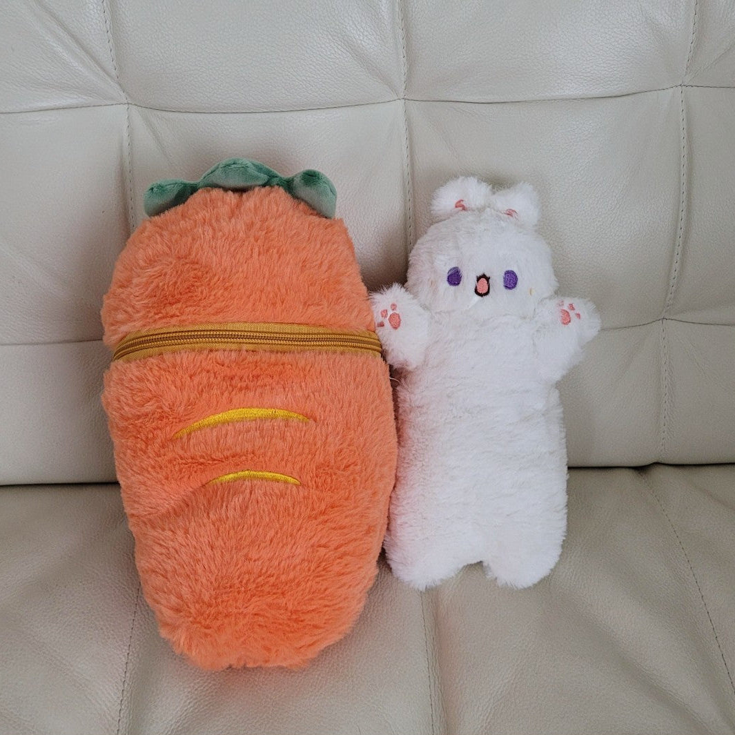 Plush carrot and plush bunny on a beige couch